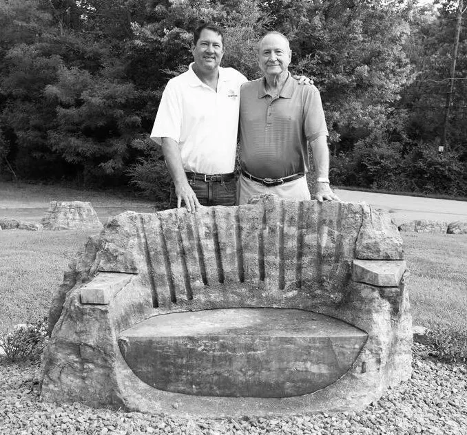 John Liter and Bob Liter beside a carved limestone bench, 2018